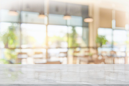 White marble table top on blur coffee shop window background. For product or foods montage.の写真素材