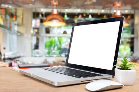 Desk Laptop with blank screen on table  blur background with bokeh background that is used for editing.の写真素材