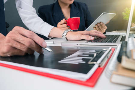 Business team present, professional investor working new start up project, Finance managers meeting,computer design smart phone using, warm colours sun light.の写真素材