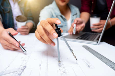 Cooperation Corporate Achievement Planning Design Draw Teamwork Concept, close-up Of Person's engineer Hand Drawing Plan On Blue Print with architect equipment.の写真素材