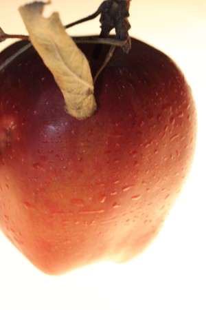 red apple with dried leaves isolated on white backgroundの写真素材