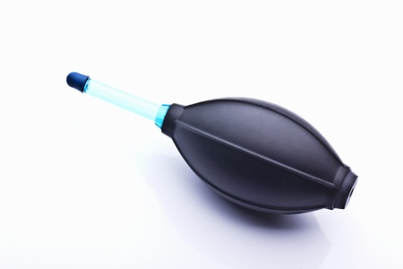 blower to clean the photo equipment on a white background