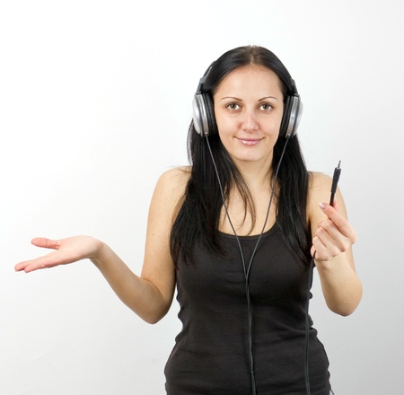 Young beautiful happy women listening music in headphonesの写真素材