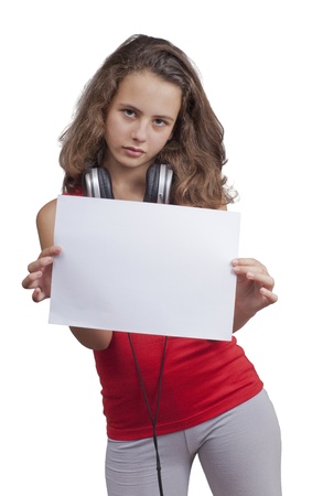 Young girl, with red T-shirt, holding a blank sheet of paper and having a headphones on her neck,  isolated on a white backgroundの写真素材