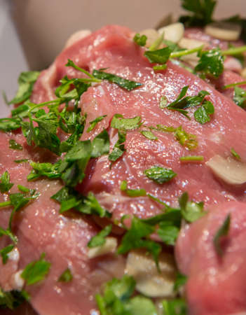 Steaks with garlic and fresh parsleyの写真素材