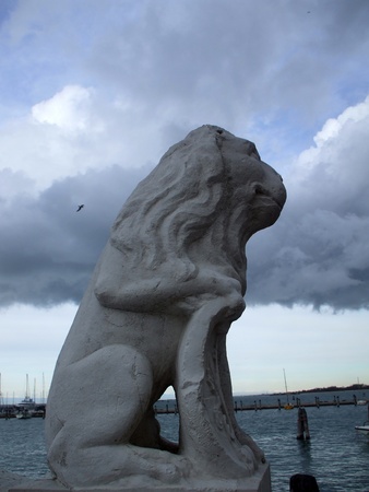 sculpture of a lion who holds a paw emblemの写真素材