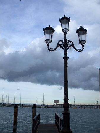 lights on the seafront on the background of thundercloudの写真素材