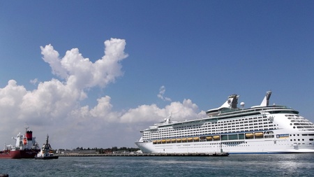pilot accompanies a tanker in port on the background of a cruise shipのeditorial素材