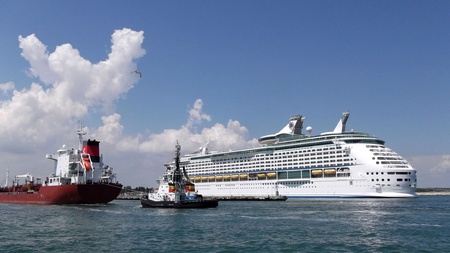 pilot accompanies a tanker in port on the background of a cruise shipのeditorial素材