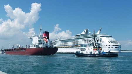 pilot accompanies a tanker in port on the background of a cruise shipのeditorial素材