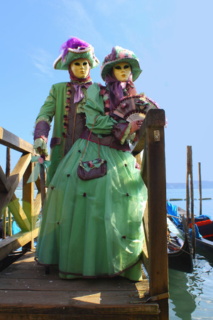 couple in carnival costume on background gondolas のeditorial素材