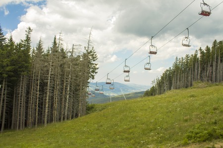 Chairlift ski lift in European Alps. Transporting hikers in summer season.の写真素材