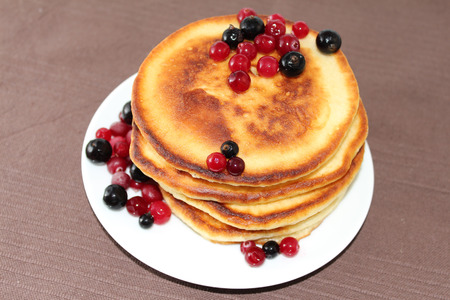 A pancake is a flat cake, often thin, and round, prepared from a starch-based batter that may also contain eggs, milk and butter and cooked on a hot surface such as a griddle or frying pan, often with oil or butter. They may be served at any time with a vの写真素材