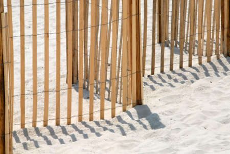 Picket fence on white sand beach in Panama City Florida USA. Used to protect and conserve the dune grass on the beach. の写真素材