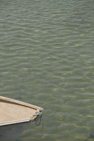 Bow of a small boat in the water by the coast.の写真素材
