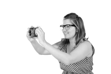 Retro black and white monochrome of beautiful young blond woman holding an antique camera  Hair...