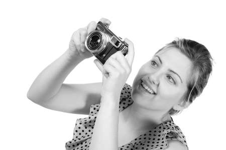 Retro black and white monochrome of beautiful young blond woman holding an antique camera  Hair teased up in bun  Photo in studio on white background and in Black and white  の写真素材