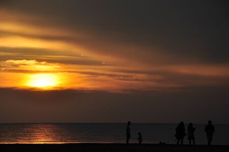 people playing beside the beach during sunsetの写真素材