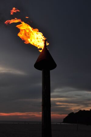 Fire torch during sunsetの写真素材