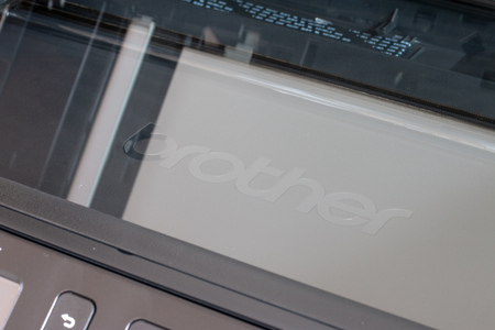 DE LIER, NETHERLANDS - AUGUST 28 2018: Brother printer logo under the scan glass of a brand new...