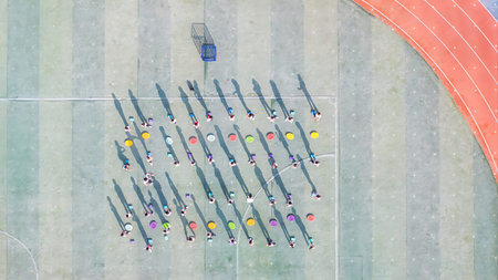 Aerial view of people playing basketball at outdoor court. Top view.