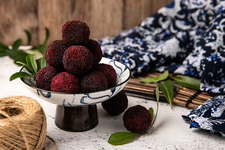 Blackberries in a bowl on a wooden background. Selective focus.