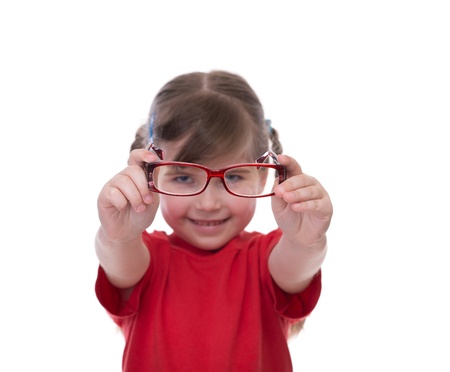 Cute little girl holding glasses and looking thru it isolated on whiteの写真素材