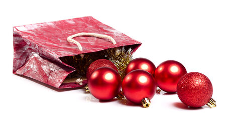 new year red balls fall of the bag on whiteの写真素材