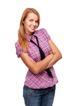 Young woman standing and smiling folded her hands in studioの写真素材