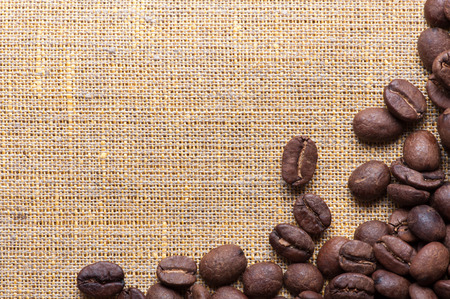 corner decoration of coffee beans on piece of sacking materialの写真素材