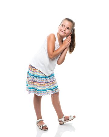 little girl dancing clap hands and looking asideの写真素材