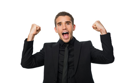 young successful man put his hand up and rejoices victoryの写真素材