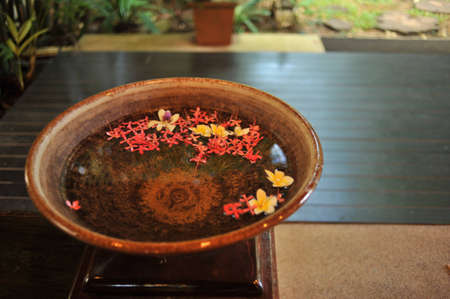 basin of water and flowersの写真素材