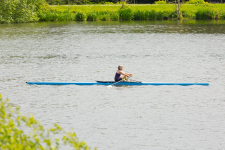 Newcastle-under-Lyme, Staffordshire-united kingdom April, 14, 2022 Women Rower in a boat, rowing on...
