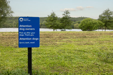 attention dog owners sign in blue educating people to pick thier dogs poo upのeditorial素材