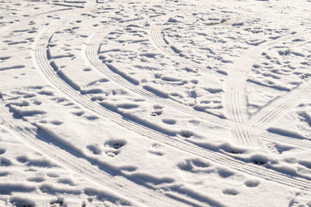imprint of a truck tire on the snowy road in winterの写真素材