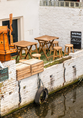 A small street cafe in Amsterdam, a view of the canal.の写真素材