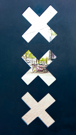 View through three X, the symbol of Amsterdam. Bicycles in the background.の写真素材