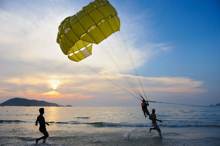 Phuket, Thailand - February 6,2011: An Unidentified man parasails under the blue sky at sunset on FEB 6,2011 at Patong Beach, Phuket province, Thailandのeditorial素材