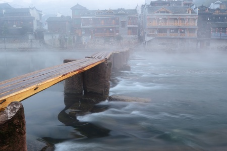 China river landscape with wooden bridge and traditional building in Fenghuang county, Hunan provinceの写真素材
