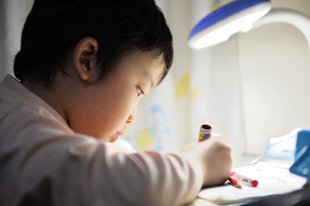 Little Asian kid doing her homeworkの写真素材