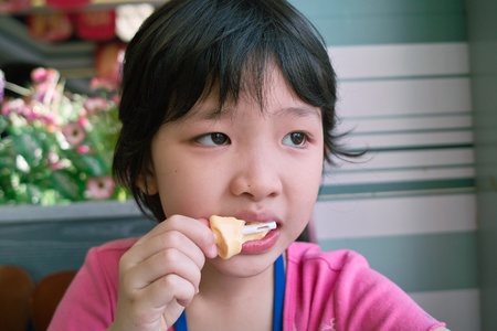 Asian little kid eating cheese