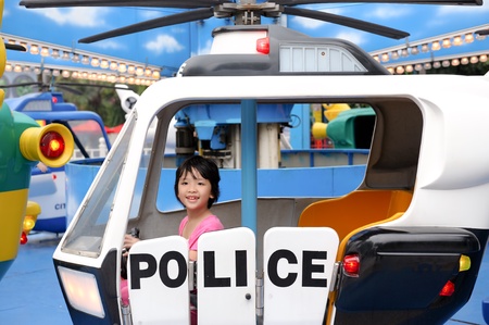 Asian little kid playing in the amusement parkの写真素材