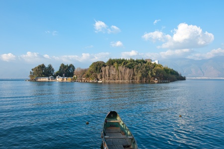 Lake landscape with boat foreground in Dali, Yunnan province of Chinaの写真素材