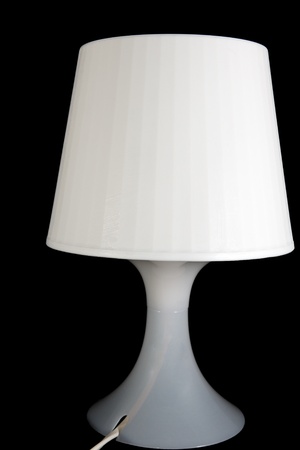 White desk lamp isolated on black backgroundの写真素材