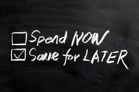 Chalboard drawing - Spend now or save for laterの写真素材