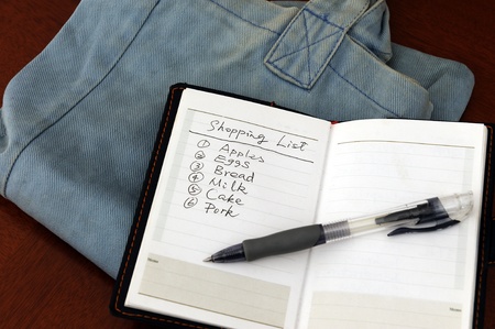 Notepad of shopping list  on the shopping bagの写真素材