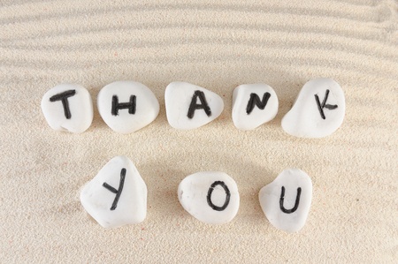 Thank you words on group of stones with sand as backgroundの写真素材
