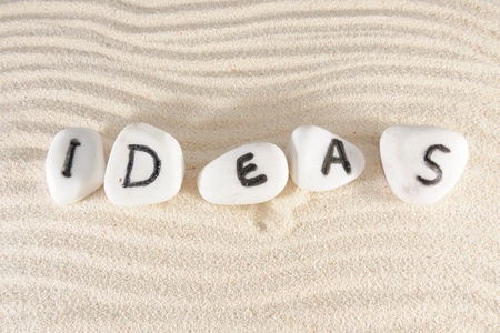 Ideas word on group of stones with sand as backgroundの写真素材