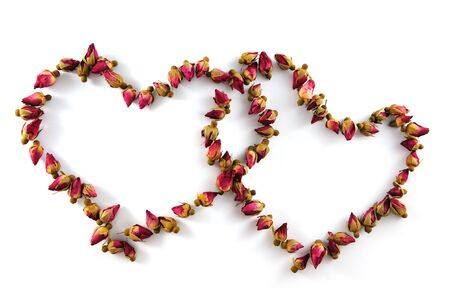 Two heart symbols made of dried flowers on white backgroundの写真素材